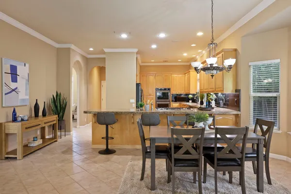a view of a dining room with furniture and chandelier