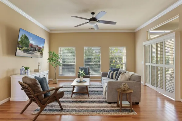 a living room with furniture and a floor to ceiling window