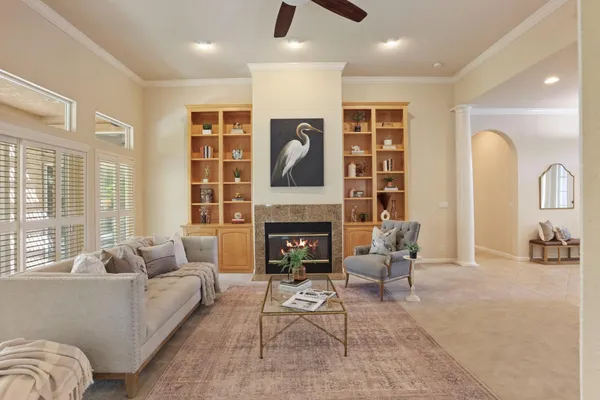 a living room with furniture and a fireplace