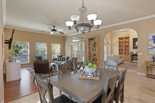 a view of a dining room with furniture wooden floor and chandelier