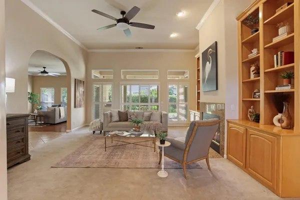 a living room with furniture a large window and flat screen tv