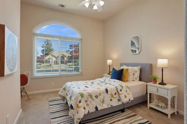 a bedroom with a bed and a window