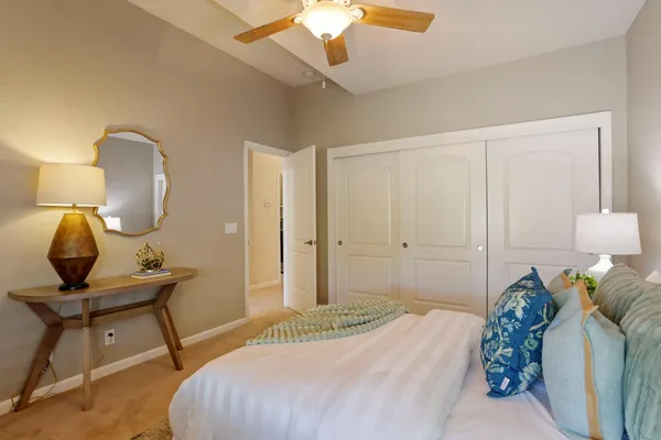 a bedroom with a bed and a mirror