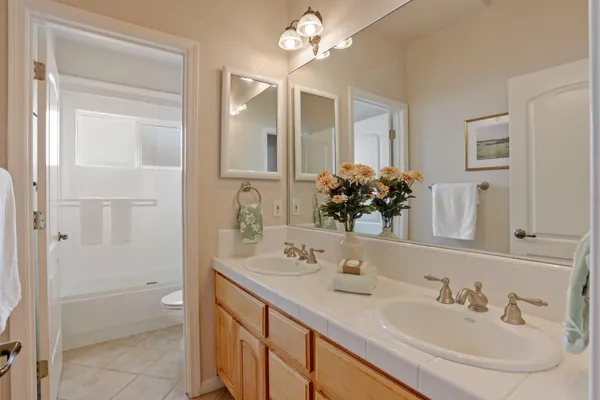 a bathroom with a double vanity sink and a mirror