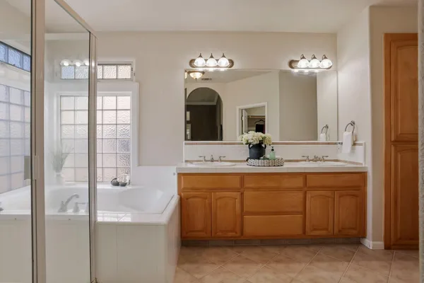 a bathroom with a double vanity sink and a mirror