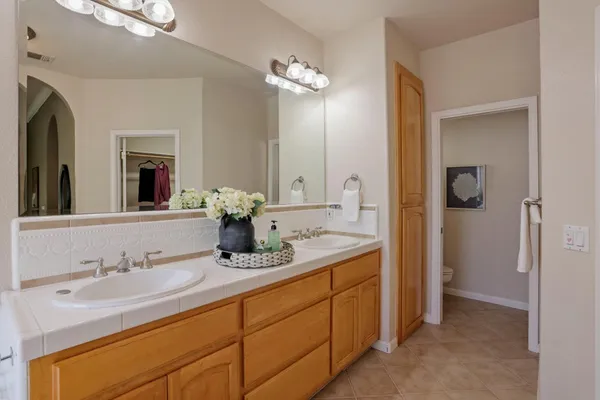 a bathroom with a double vanity sink and a mirror