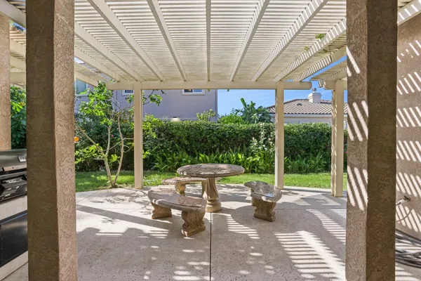 a view of a patio with table and chairs potted plants with wooden floor and fence