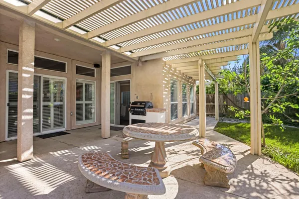 a view of a porch with furniture and garden