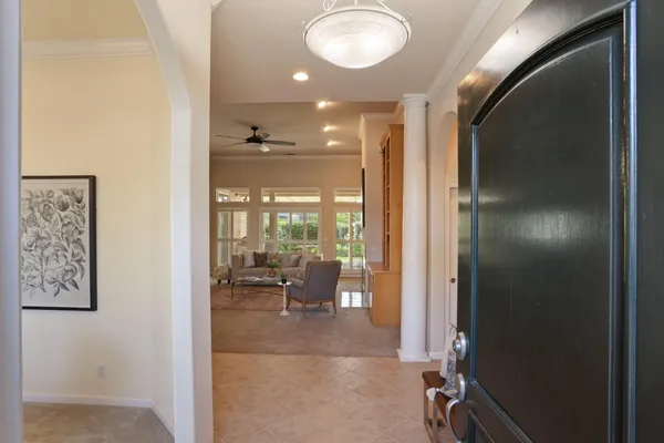 a view of a hallway with dining area and glass door