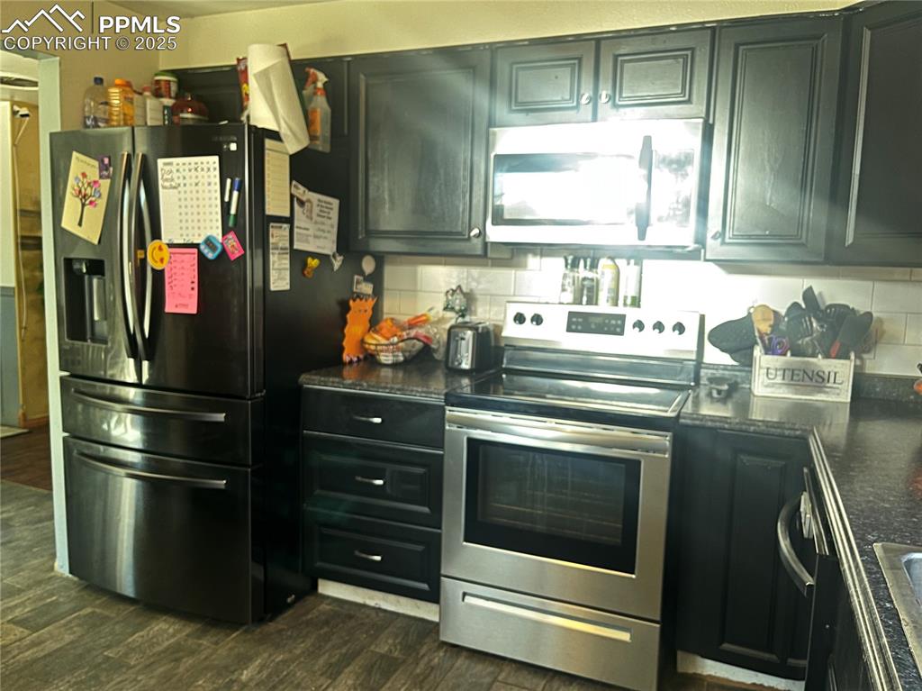 66 Louis Nelson Road Pueblo, CO 81001 - Photo 7 of 29 a kitchen with granite countertop stainless steel appliances and wooden cabinets