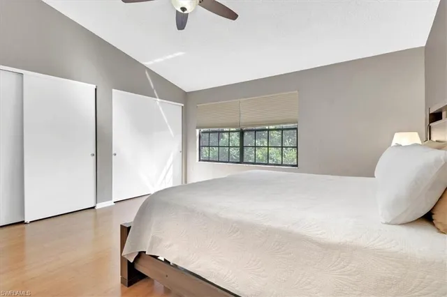 a bedroom with a bed and a large window