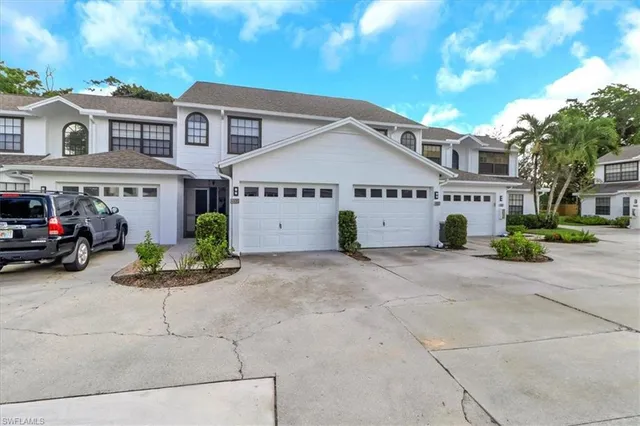 a front view of a building with a garden and fire pit
