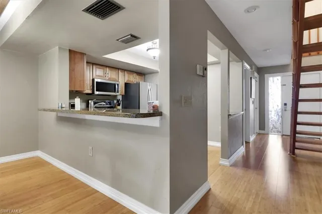 a view of a kitchen from the hallway
