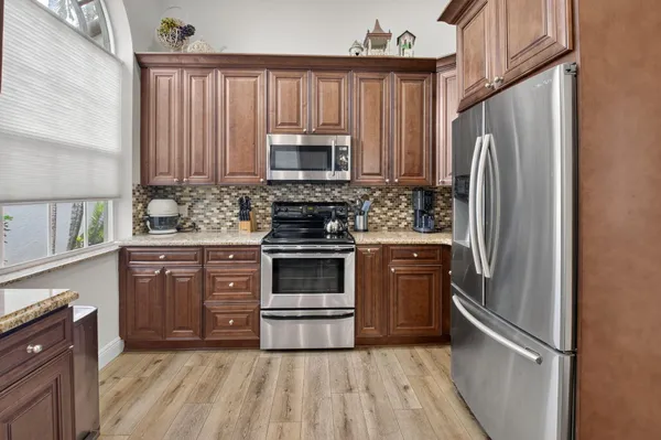 a kitchen with a refrigerator stove and microwave