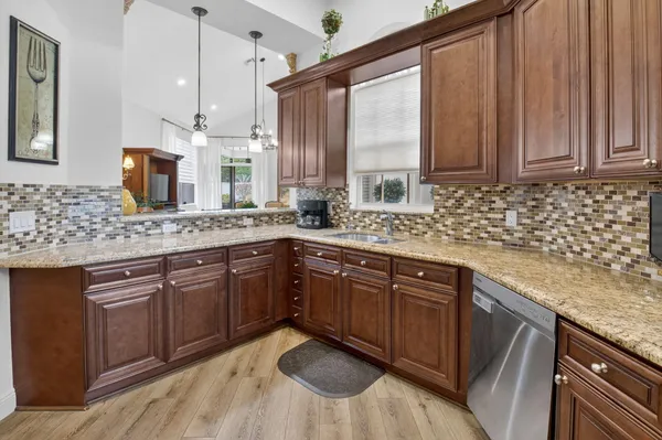 a kitchen with a sink stove and cabinets