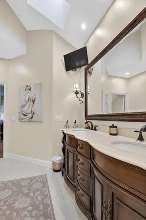a bathroom with a double vanity sink mirror and toilet