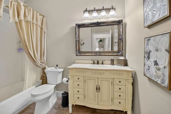 a bathroom with a sink vanity mirror and toilet