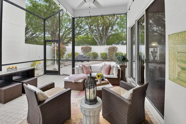 a living room with furniture and a floor to ceiling window
