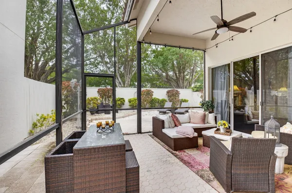 a living room with furniture and a floor to ceiling window