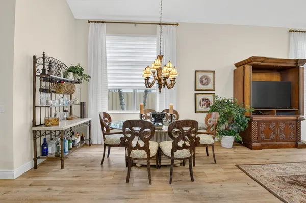 a view of a dining room with furniture and wooden floor