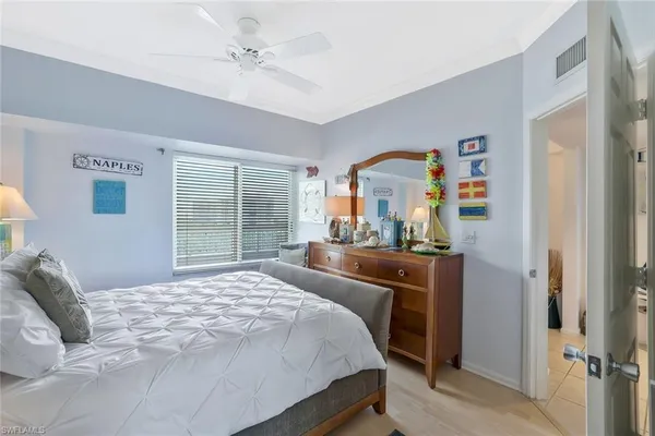 a bedroom with a bed dresser and a window