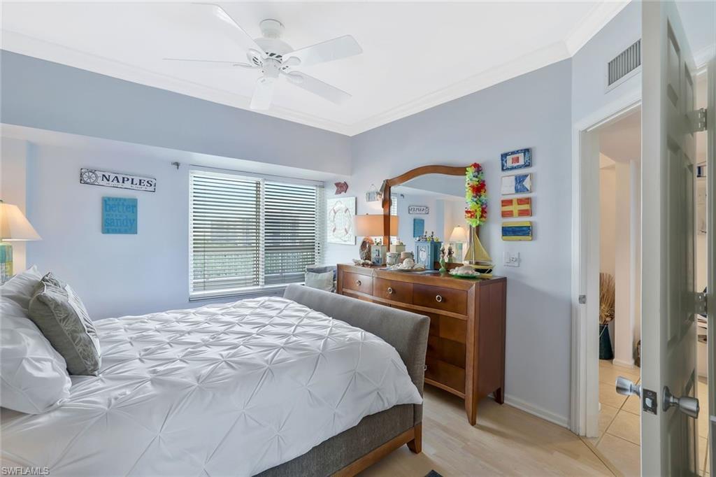 25 Bluebill Avenue, Unit 1103 Naples, FL 34108 - Photo 11 of 22 a bedroom with a bed dresser and a window