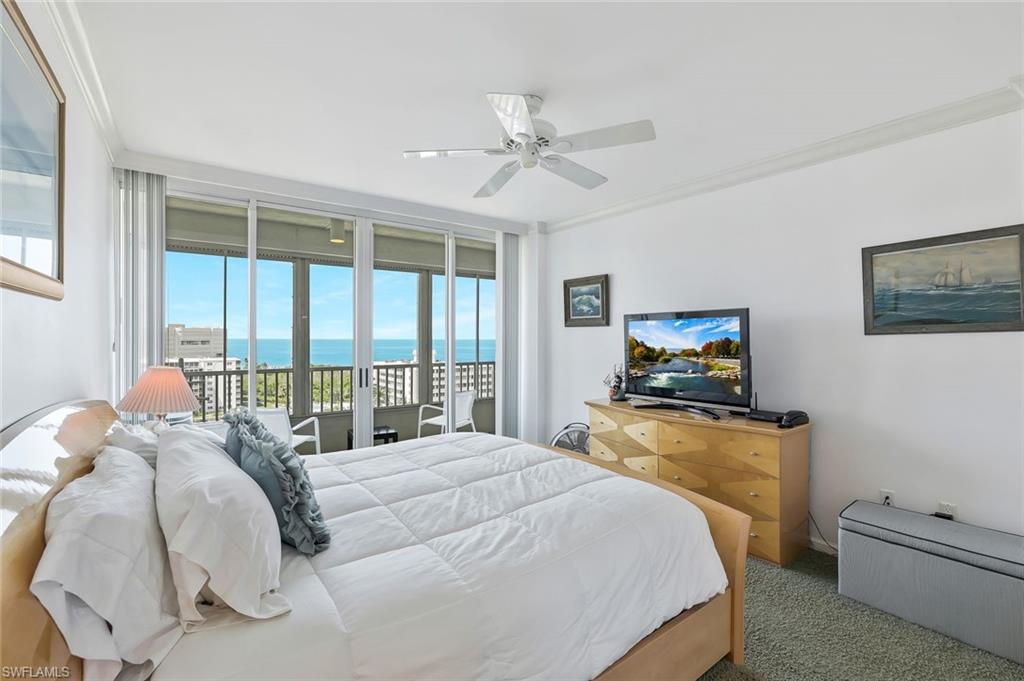 25 Bluebill Avenue, Unit 1103 Naples, FL 34108 - Photo 14 of 22 a bedroom with a bed and wooden floor
