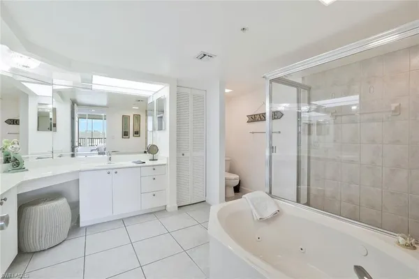 a bathroom with a granite countertop sink a toilet and shower