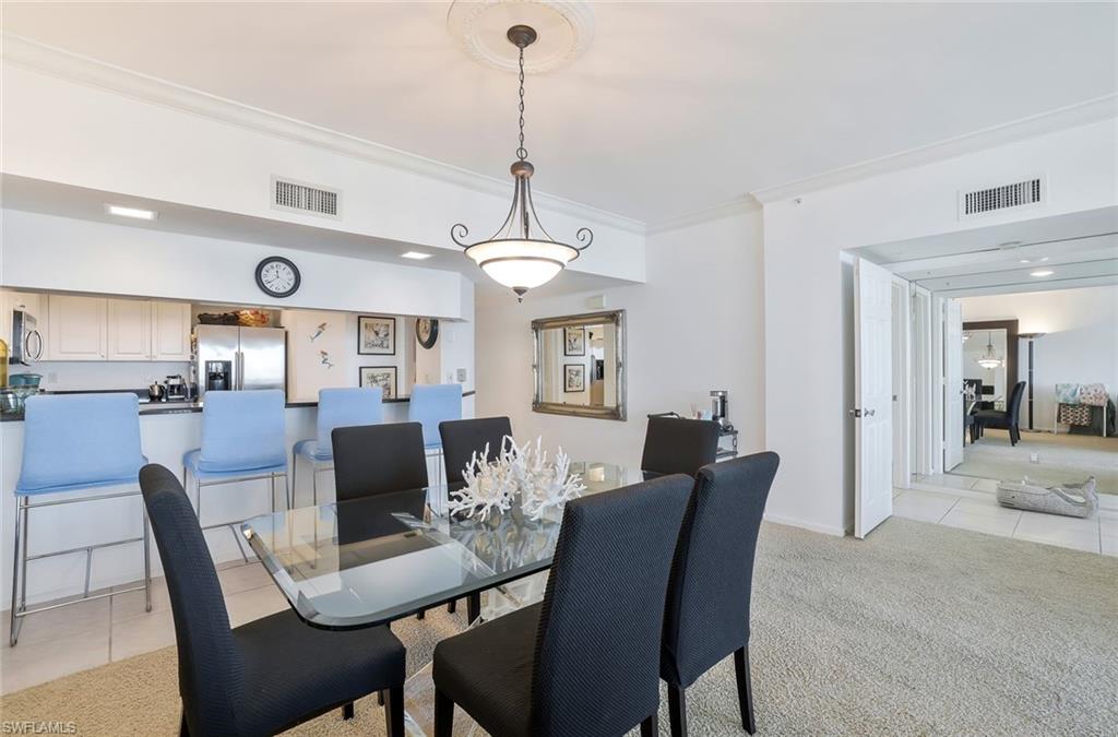 25 Bluebill Avenue, Unit 1103 Naples, FL 34108 - Photo 6 of 22 a view of a dining room with furniture