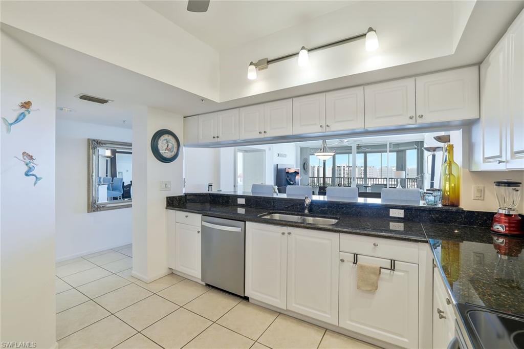 25 Bluebill Avenue, Unit 1103 Naples, FL 34108 - Photo 7 of 22 a kitchen with a sink and cabinets