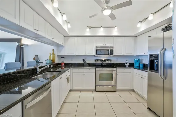a kitchen with stainless steel appliances granite countertop a sink and cabinets
