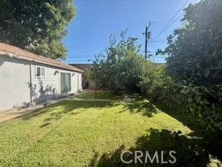 a view of house with backyard and garden
