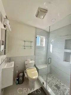 a bathroom with a toilet sink and shower