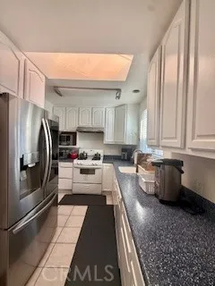 a kitchen with stainless steel appliances a refrigerator sink and cabinets