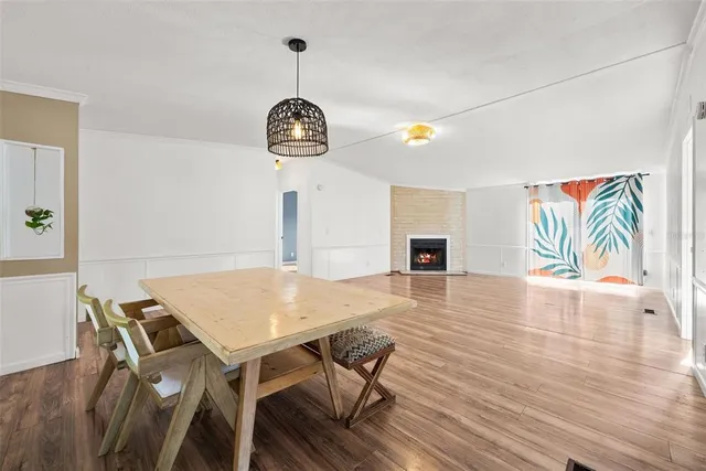 a view of a dining room with furniture wooden floor and chandelier