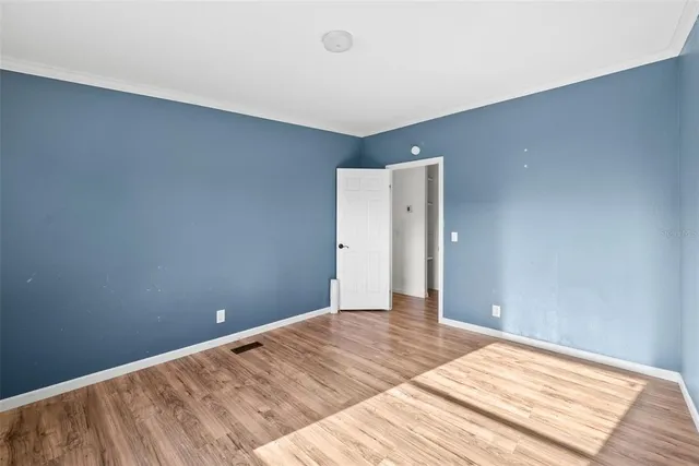 a view of a room with wooden floor