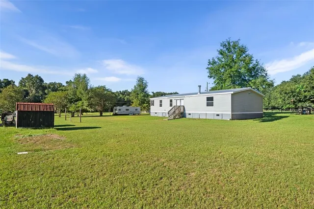 a front view of a house with a yard and a garage