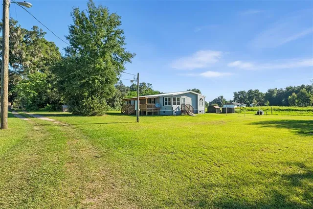 a house view with swimming pool in front of it