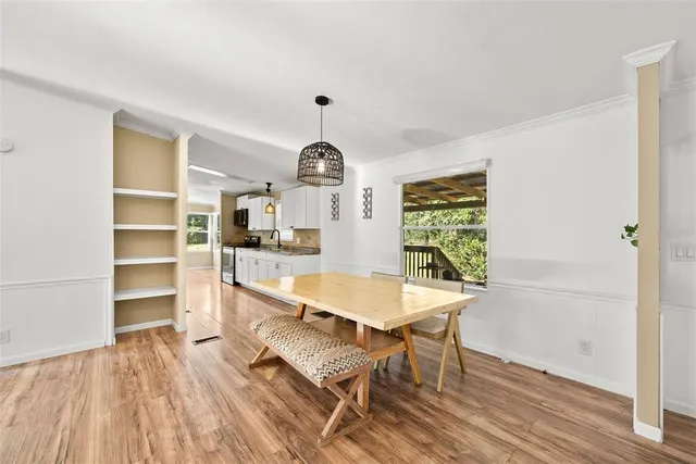 a living room with furniture and a open kitchen view