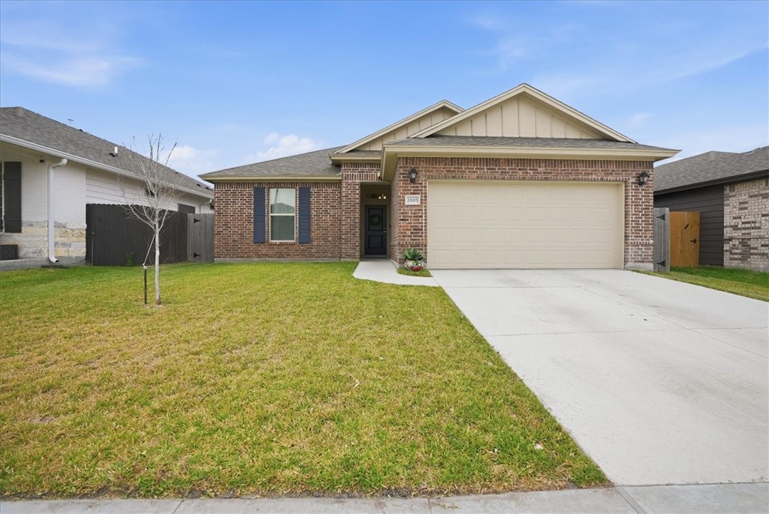 a front view of a house with a yard and garage