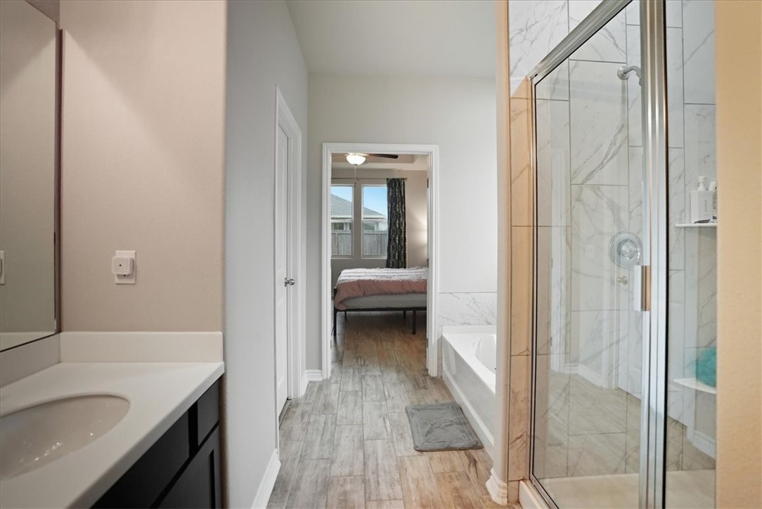 2685 Westeros Street Corpus Christi, TX 78415 - Photo 16 of 24 a en suite bathroom with a sink and a large mirror