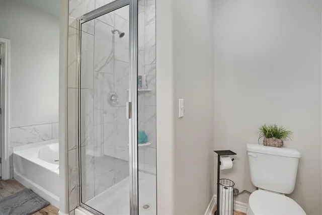 a bathroom with a toilet and a shower