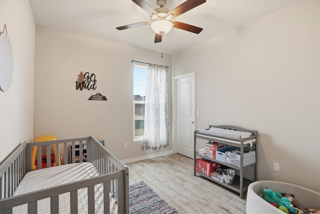 2685 Westeros Street Corpus Christi, TX 78415 - Photo 19 of 24 a living room with baby crib furniture and a window