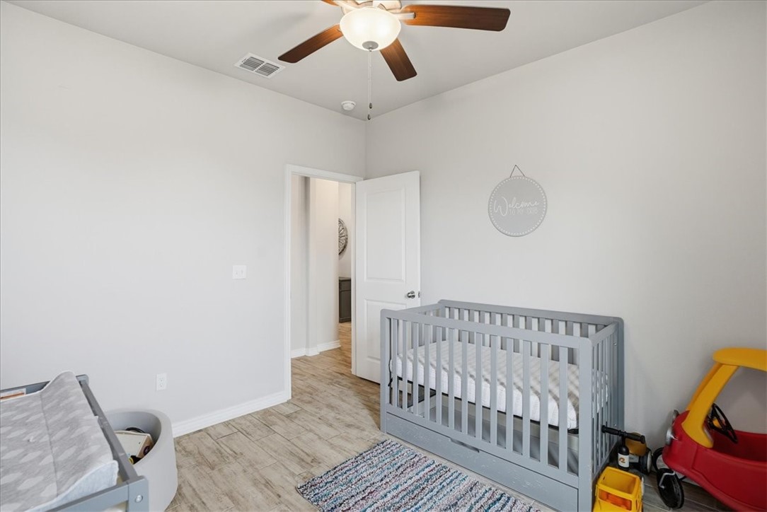 2685 Westeros Street Corpus Christi, TX 78415 - Photo 20 of 24 a bedroom with a bed and wooden floor