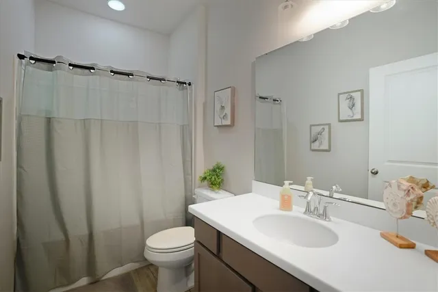 a bathroom with a sink toilet and a mirror