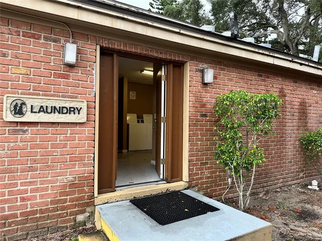 a view of a garden with a bench and wooden fence