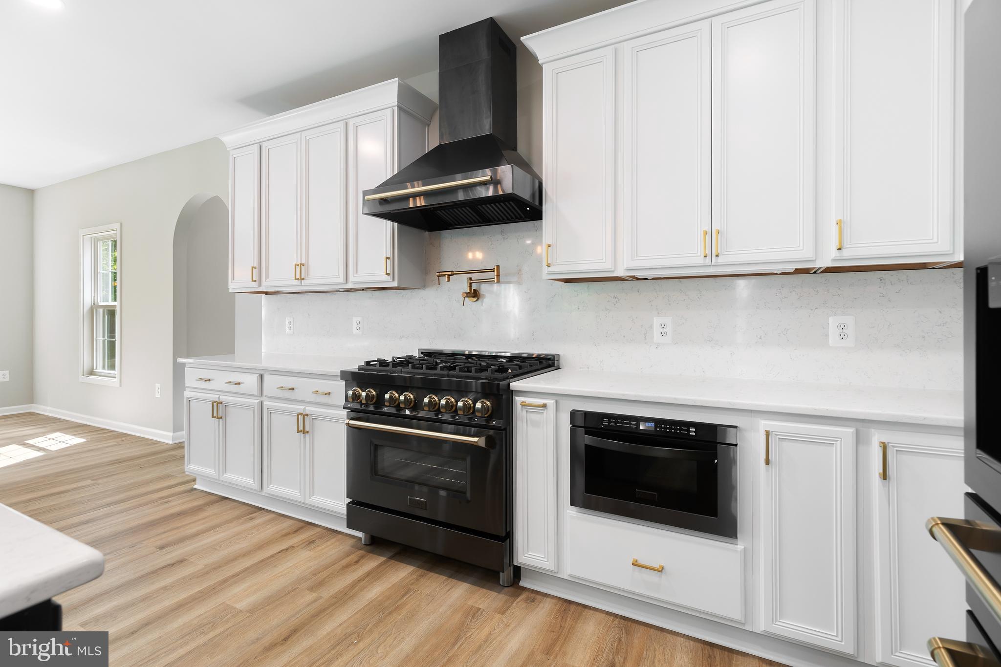 1 Riley Road Warrenton, VA 20187 - Photo 8 of 24 a kitchen with granite countertop a stove a microwave and cabinets