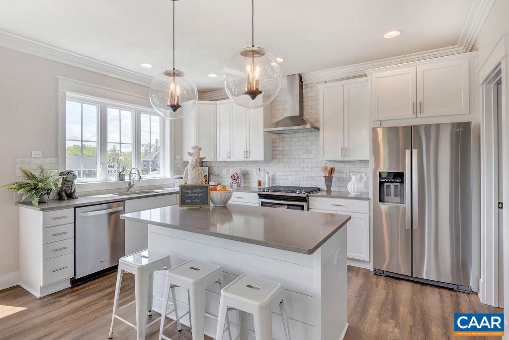 1445 Thompson Farm Road Charlottesville, VA 22901 - Photo 12 of 33 a kitchen with stainless steel appliances granite countertop a refrigerator a sink dishwasher a stove a dining table and chairs with wooden floor