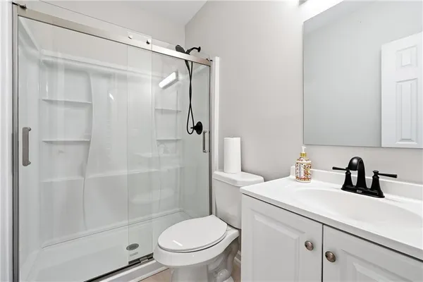 a kitchen with stainless steel appliances a white stove top oven a sink dishwasher and a refrigerator with wooden floor