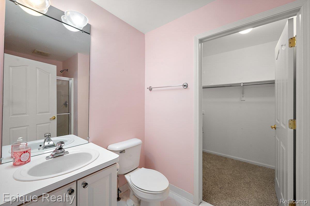 1909 Catlin Drive Rochester, MI 48306 - Photo 42 of 76 Bathroom featuring a vanity with an integrated sink, polished chrome faucet, and a large wall-mounted mirror